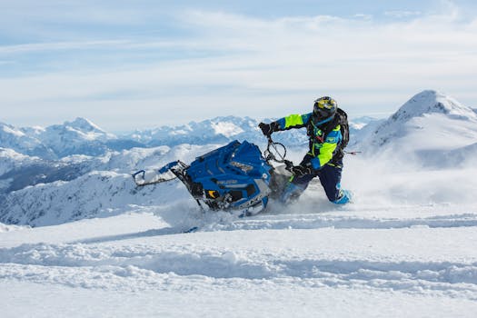 Experience the thrill of snowmobiling in breathtaking alpine landscapes during winter.
